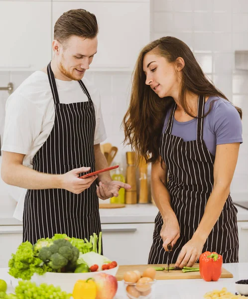 Delighted Couple Aprons Drinking Hot Beverages Counter Modern Kitchenware Light — Stock Photo, Image