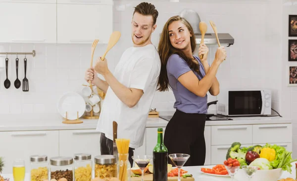Couple Looking Each Other Having Fun Wooden Spatulas Table Various — Stock Photo, Image