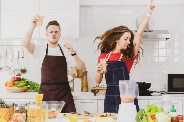 Positive Couple Aprons Dancing Glasses Table Assorted Ingredients Blender While — Stock Photo, Image