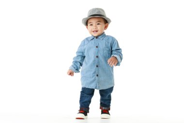 Güzel bir Asyalı çocuk portresi. Güzel bir şapkayla gülümsüyor ve açık havada oynamaktan mutlu. Çekici masum çocuk sağlıklı görünüyor, neşeli bir şekilde çocukluk hayatı gibi yürümekten zevk alıyor..