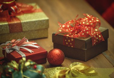 Kazaklı kadın, Noel festivalinin ev partisi dekorasyonuna harika bir hediye hazırlamak için muhteşem bir süs ve renkli kurdele ile altın renkli hediye kutusu koydu.