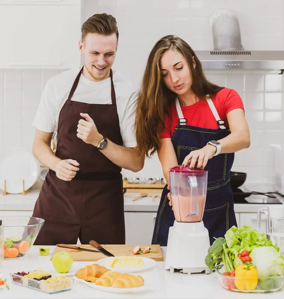 Coppia Positiva Grembiuli Felici Insieme Durante Preparazione Frullato Rinfrescante Con — Foto Stock