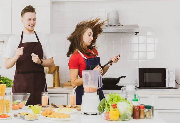 Optimistic Couple Aprons Dancing Table Assorted Ingredients Blender While Cooking — Stock Photo, Image