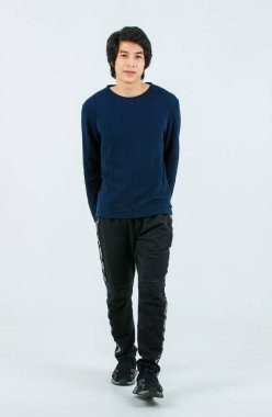 Portre izole edilmiş tüm vücut stüdyosu Asyalı yakışıklı, kendine güveni tam, sağlıklı, uzun kollu spor pantolonlu, spor ayakkabılı, beyaz arka planda poz veren genç, atletik erkek model..