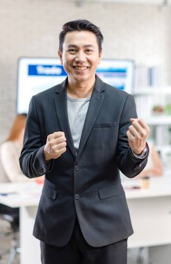 Portrait shot Asian happy cheerful smart confident millennial professional successful male businessman entrepreneur in casual blazer suit standing crossed arms smiling in company office meeting room.