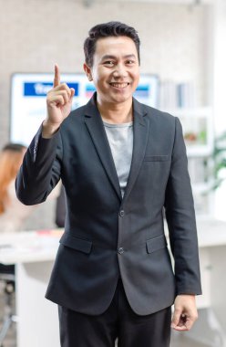 Portrait shot Asian happy cheerful smart confident millennial professional successful male businessman entrepreneur in casual blazer suit standing crossed arms smiling in company office meeting room.