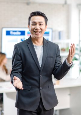 Portrait shot Asian happy cheerful smart confident millennial professional successful male businessman entrepreneur in casual blazer suit standing crossed arms smiling in company office meeting room.