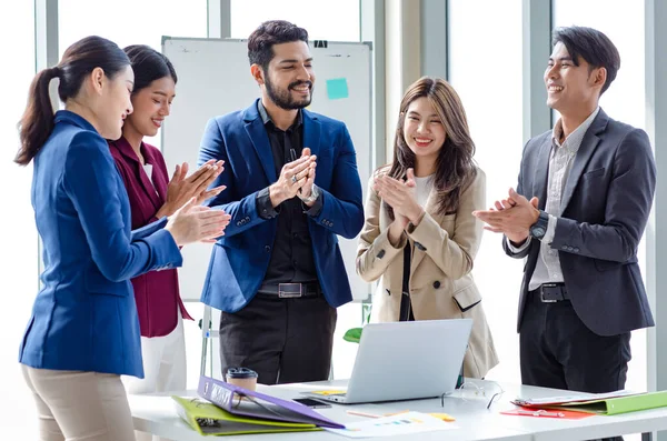 Millennial Indian Asian professional successful male female businessman businesswoman group in formal suit discussing brainstorming sharing business solution ideas in company conference meeting room.