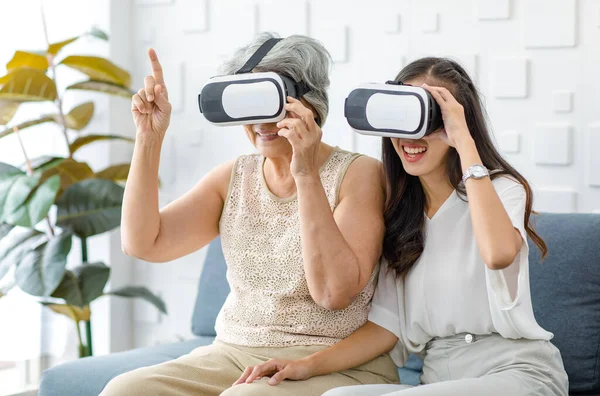 Asian Young Cheerful Daughter Wearing Virtual Reality Goggles Headset Sitting — Fotografia de Stock