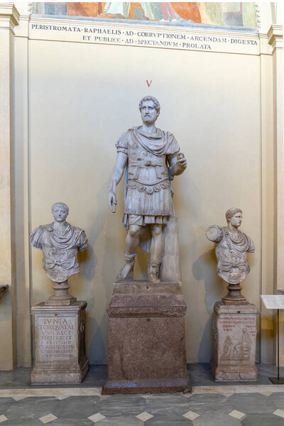 Statue flanked by two busts of Roman warlords in one of the museums in Vatican City, Rome