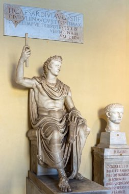 A marble statue of a seated Tiberius Caesar, son of emperor Augustus, in one of the museums in Vatican City, Rome