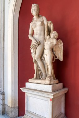 One of the few marble statues of a woman flanked by an angel in one of the museums in Vatican City, Rome
