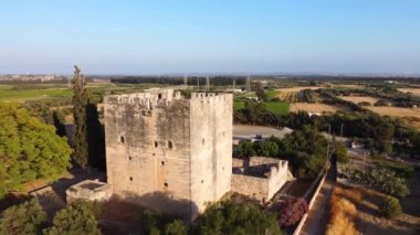 Aerial drone 360 orbit footage of the medieval castle of Kolossi, situated in the south of Cyprus, in Limassol from above. The castle dates back to the crusades and it constitutes a landmark of the area.