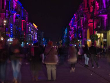 Uzun sokağın renkleri. Lodz, Polonya - 29 Eylül 2017 Lodz Piotrkowska Caddesi 'ndeki kasaba evleri, Işık Festivali sırasında etkin bir şekilde aydınlatıldı.