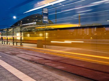 The magic of light and movement.   Lodz, Poland - August 02, 2022   Effectively blurry traffic of the city bus and trams at the Lodz Fabryczna railway station.