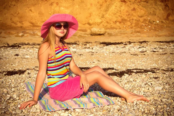 Girl on the beach in a pink hat. — Stock Photo, Image