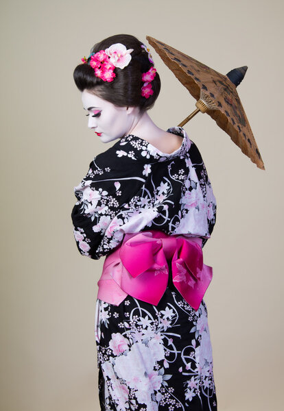 Japanese woman shows kimono with an umbrella