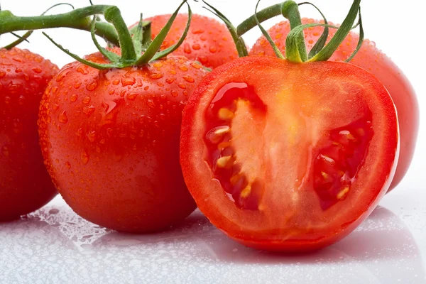 Juicy tomato sliced with drops against white background — Stock Photo, Image