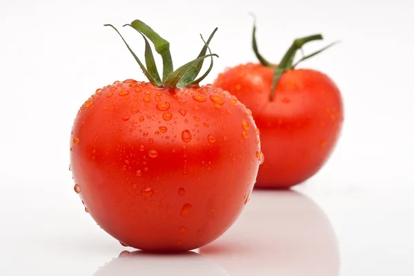 Two juicy tomatoes with drops isolated against a white background — Stock Photo, Image