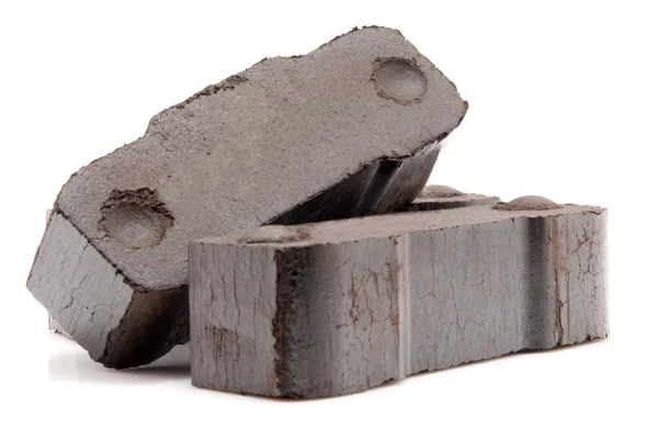 Pile of three coal briquettes isolated on white background — Stock Photo, Image