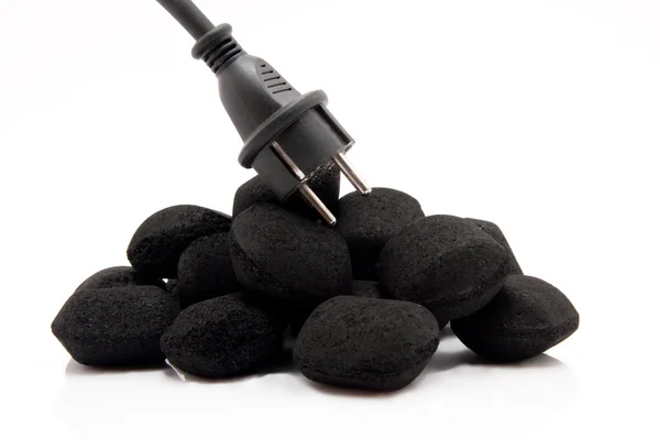 Heap of coals with a power plug as symbol of electricity generation — Stock Photo, Image