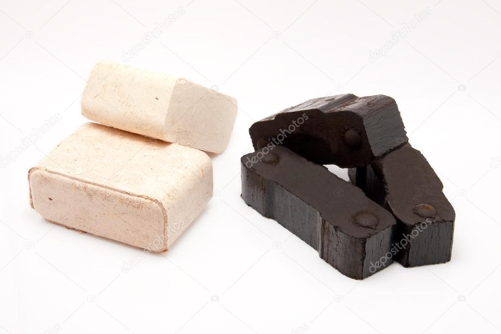 Coal briquettes and pieces of wooden fire briquettes isolated on white background