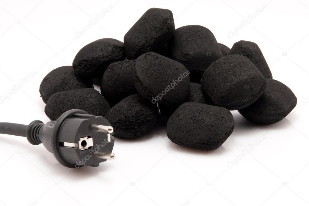 Heap of coals with a power plug as symbol of electricity generation
