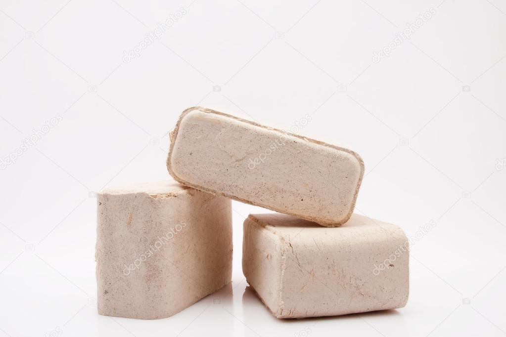 Pile of wood briquettes isolated on white background