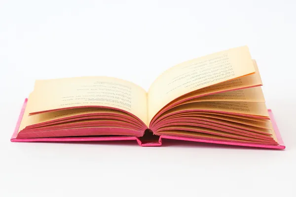 Livre rose ouvert sur blanc — Photo