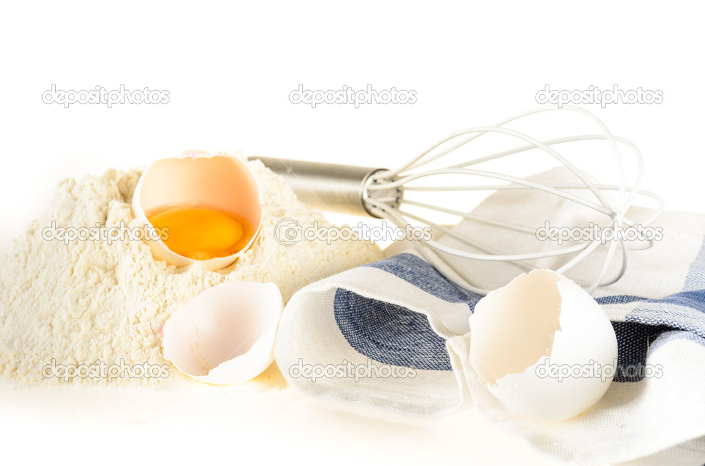 Baking ingredients and tools: eggs, flour, whisk and kitchen towel