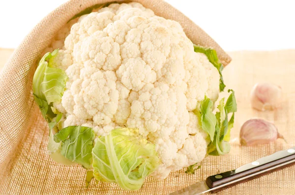 Cauliflower with burlap sack on white — Stock Photo, Image