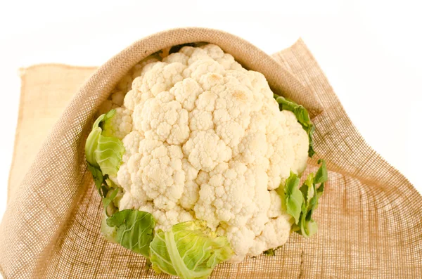 Cauliflower with burlap sack on white — Stock Photo, Image