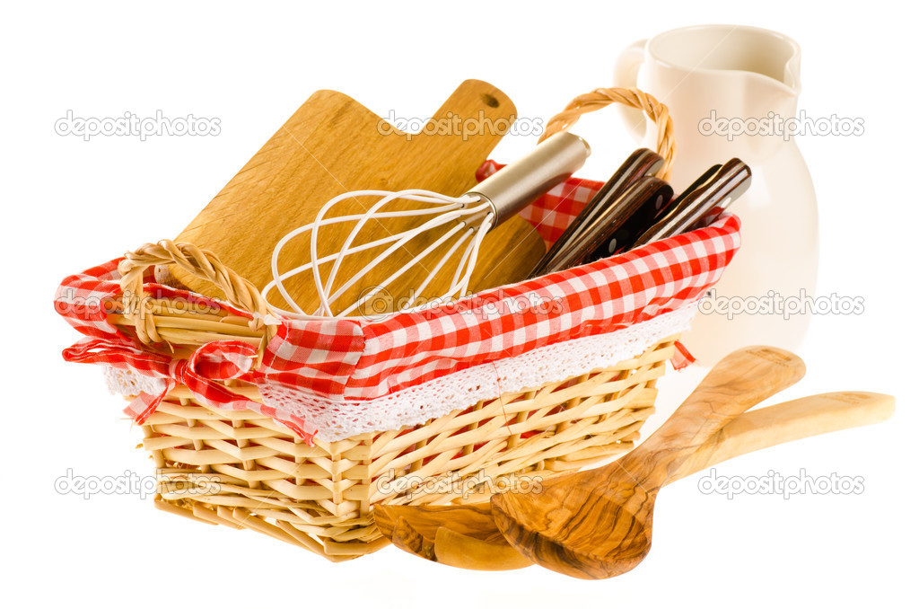 Kitchen tools in the basket, consisting of whisk, cutting board,