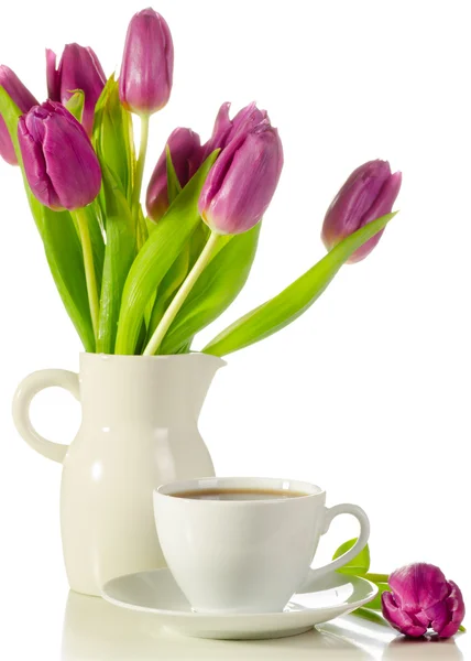 White cup of coffee with bunch of purple tulips — Stock Photo, Image
