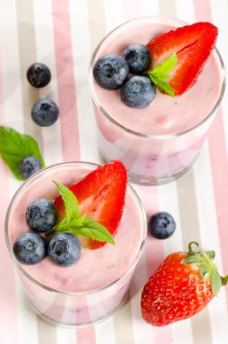 Fruit desserts with berries served in glasses clipart