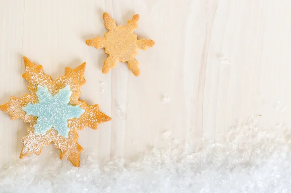 Flocon de neige décoré biscuits de Noël sur fond bois clair — Photo