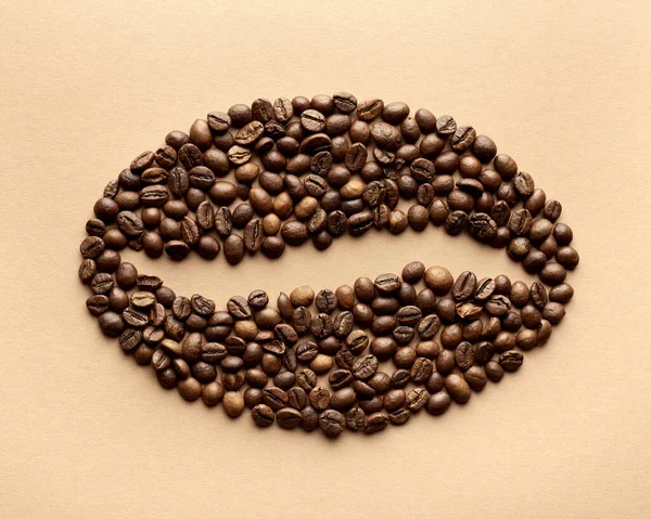 Stylized coffee bean. Styling from whole coffee beans. On a beige background. Flat lay.