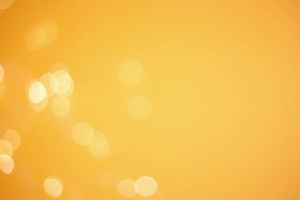 Abstract yellow bokeh defocused background. Glitter glow