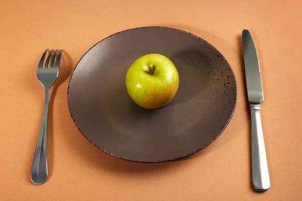 Manzana Está Sobre Plato Marrón Sobre Fondo Marrón Claro Tenedor —  Fotos de Stock