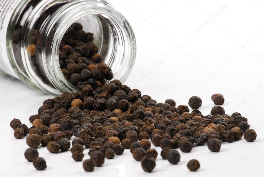 Black peppercorns and pot. Black pepper balls.
