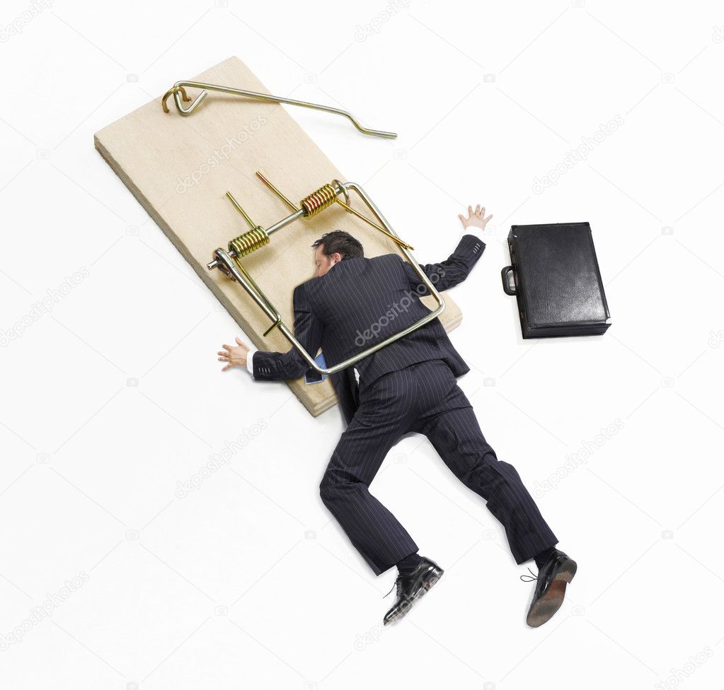 Businessman trapped on mousetrap on white background