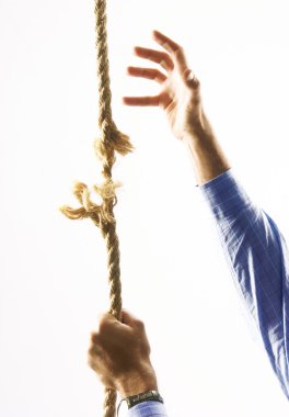 Man climbing a breaking rope. clipart