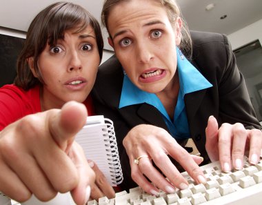 Two worried women watching a computer . clipart