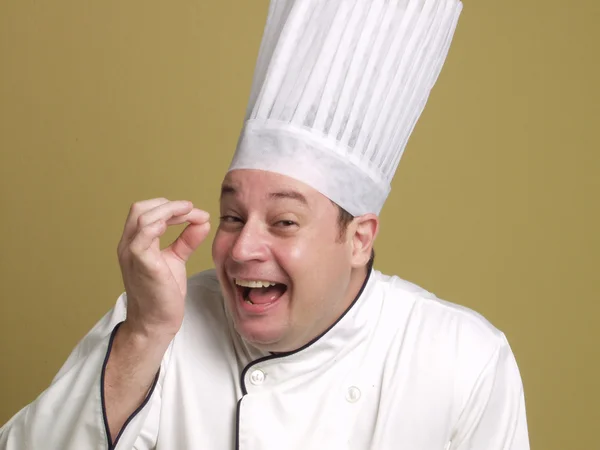 Portrait of a young chef on yellow background. — Stock Photo, Image