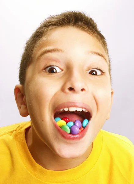 Little boy is eating candy — Stock Photo, Image