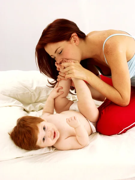 Caucasian young mother enjoying her child. — Stock Photo, Image