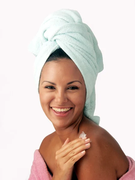 Young latin woman applying cream on her body — Stock Photo, Image