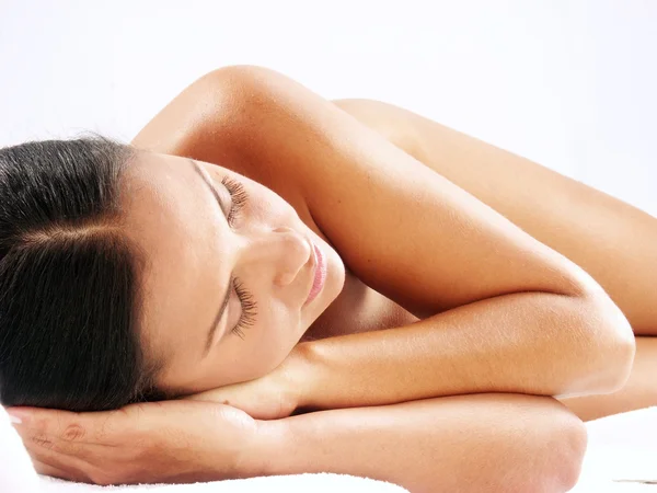 Beautiful young latin woman lying down on white background. — Stock Photo, Image