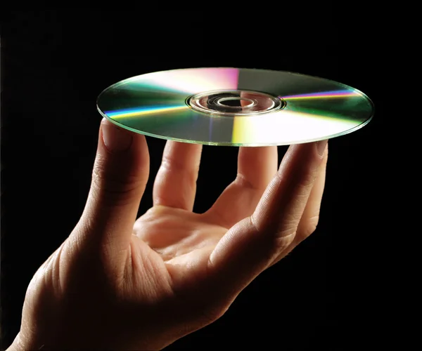 Küçük bir disk tutan el. — Stok fotoğraf