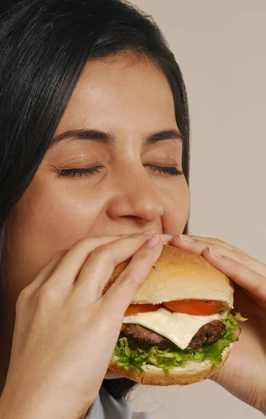 Jovem mulher comer hambúrguer — Fotografia de Stock